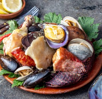 Famous traditional dish of the south of Chile and the Chiloe archipelago - Curanto Kuranto. Different seafood and meat cooked in a pit on the coals under the ground.